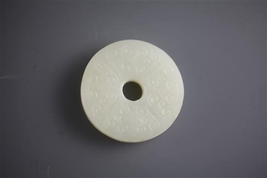 A Chinese white jade bi disc, diameter 4.6cm, wood stand